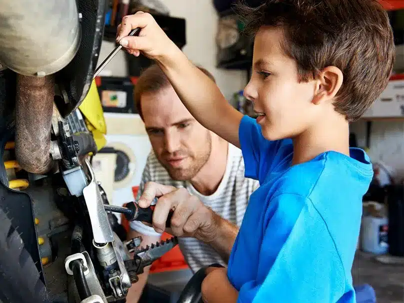 men teaching boy tools image